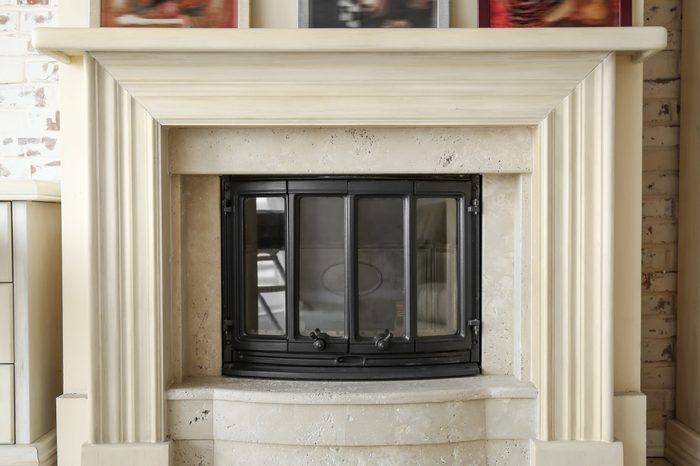 Modern beige fireplace in room