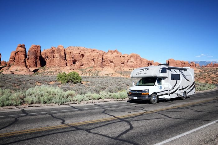UTAH, UNITED STATES - JUNE 21, 2013: Recreational vehicle drives in Arches National Park in Utah. Arches NP was visited by 1,070,577 people in 2012.