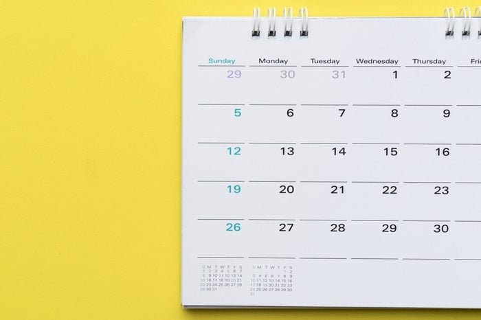 close up of calendar on yellow background, planning for business meeting or travel planning concept