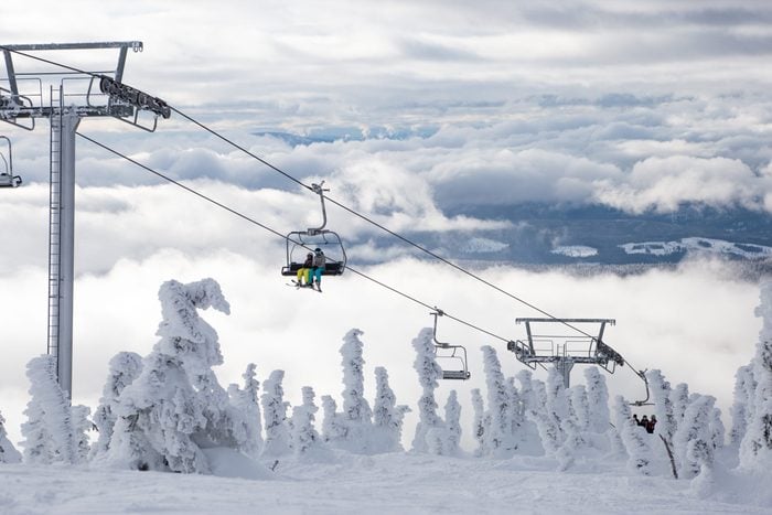 Ski or snowboard on chairlift at Big White Resort, Kelowna, British Columbia, Canada