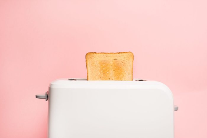 Healthy fashion food of breakfast. Toast in a toaster on a pink background.