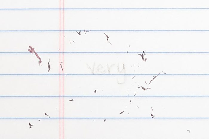 erased text "very" with eraser shavings on loose leaf paper