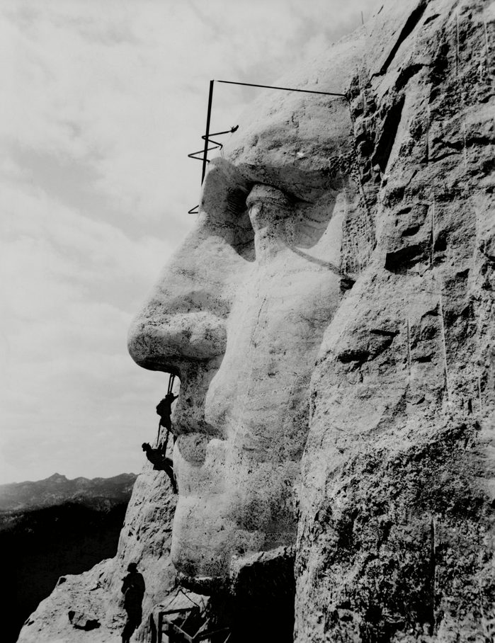 Workmen on face of George Washington at Mount Rushmore, South Dakota. 1932.