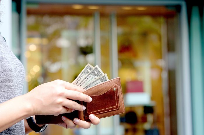 Women hold money in wallets pay shopping .background Bag and Fashion Shop