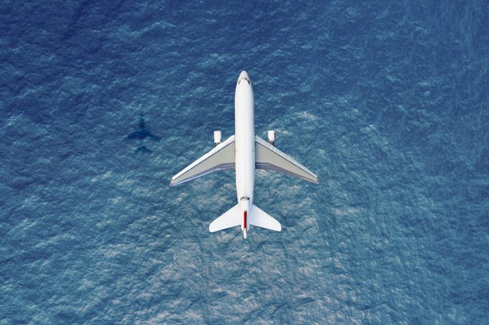 aerial view of airplane flying over water