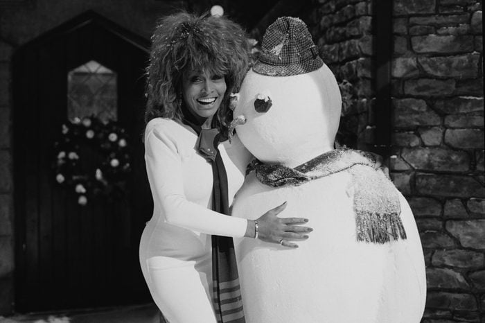 American singer Tina Turner with a model snowman, circa 1980