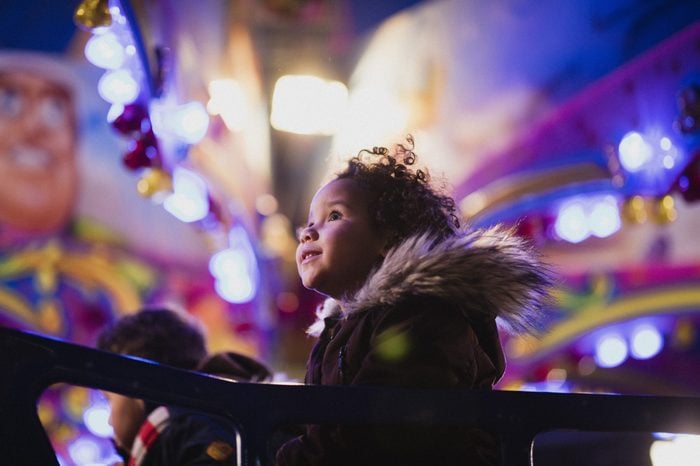close up of a child in awe on a carnival ride