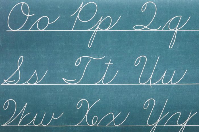 cursive letters of the alphabet written on a chalkboard