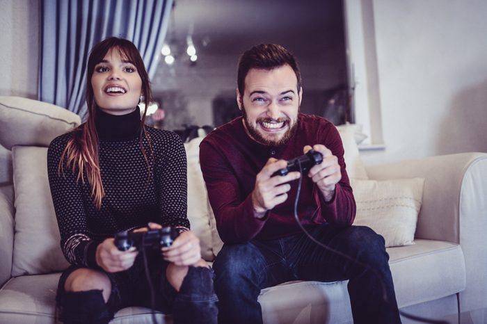 Couple Competing In Video Games At Home
