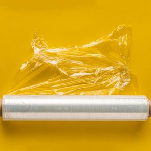 roll of plastic wrap on yellow background