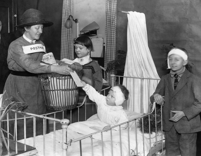 1926: Children at St Bartholomew's Hospital, London, receiving their post.