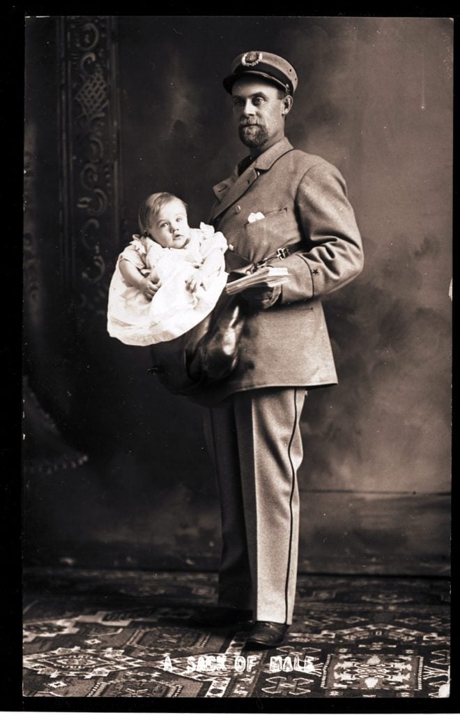 A US postman carrying a baby boy along with his letters, USA, circa 1890.
