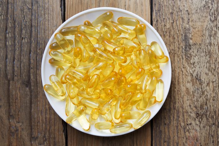fish oil in a bowl on wooden background table