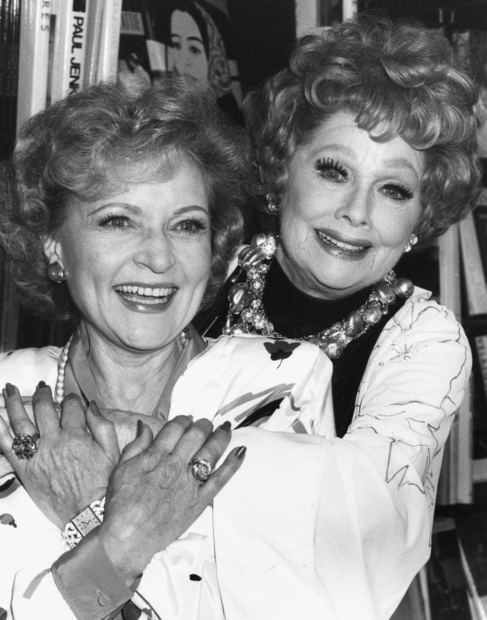 Actresses Betty White (left) and Lucille Ball embracing at a book signing event in Los Angeles, October 2nd 1987.