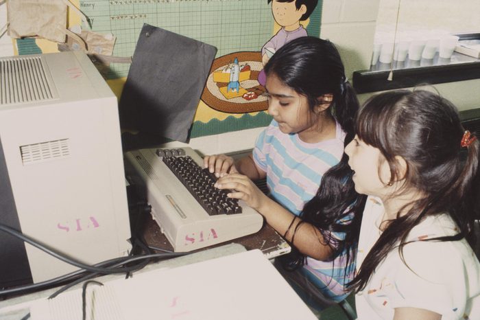 Two children using a computer in school, USA, May 1984