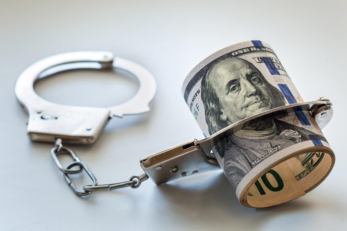 roll of money in handcuffs