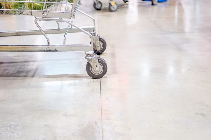 Close up shopping cart wheel at supermarket.