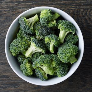 bowl of broccoli on wooden background