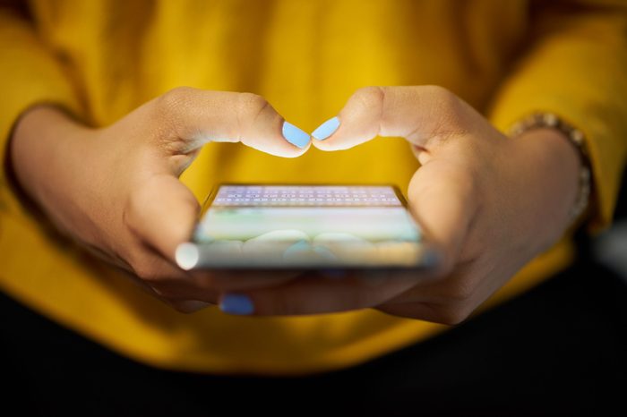 close up of hands poised and ready to type on a smartphone