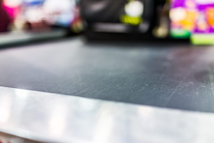 Macro closeup of grocery store checkout aisle conveyor belt