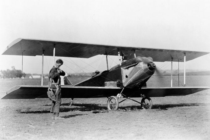 charles lindbergh standing near his airplane