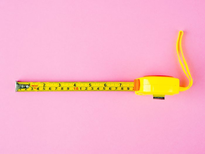 Measuring Tape on pink background