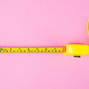 Measuring Tape on pink background