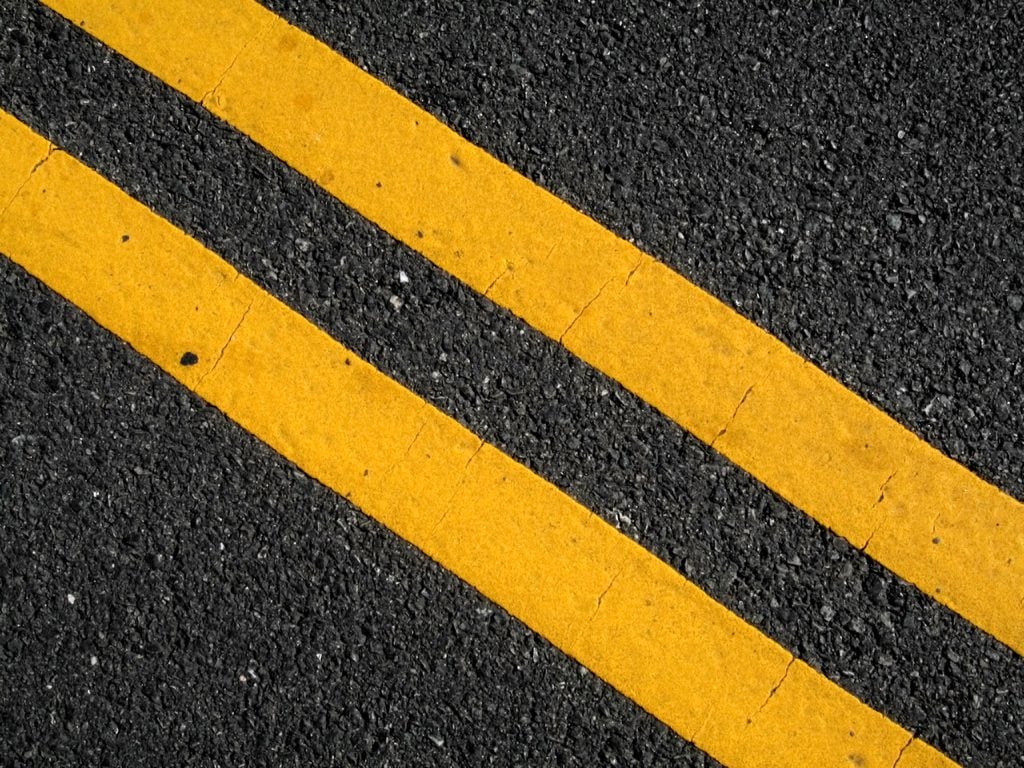 Double yellow lines on street.