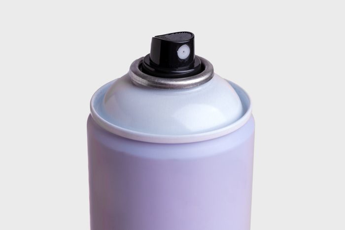 purple spray can on a grey background