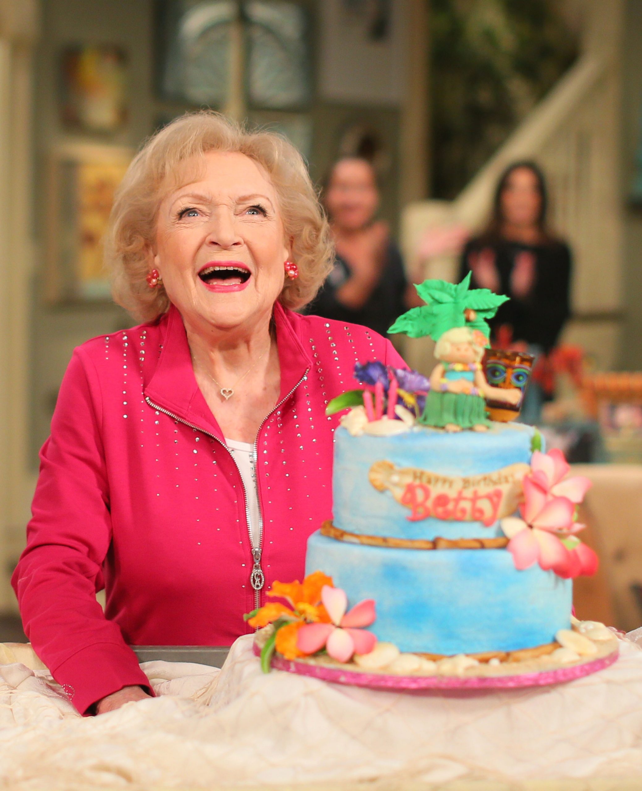 Actress Betty White poses next to her cake at the celebration of her 93rd birthday on the set of "Hot in Cleveland" January 16, 2015