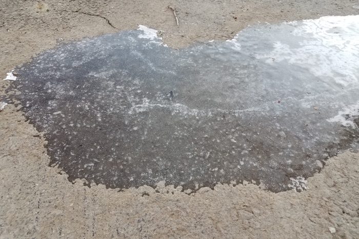 slippery black ice on asphalt or pavement