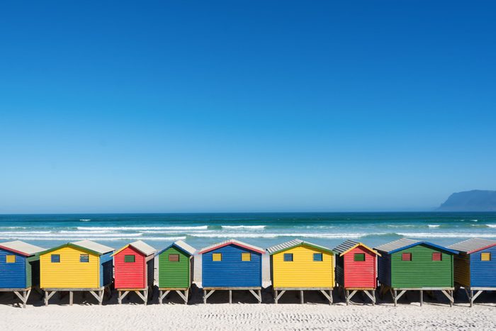 Colorful bathhouses at Muizenberg, Cape Town, South Africa, standing in a row.