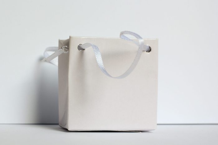 White small gift bag on soft gray background