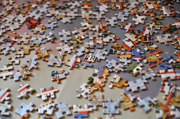 Jigsaw puzzle on the floor.Puzzle pieces.A pile of puzzle pieces on a surface.