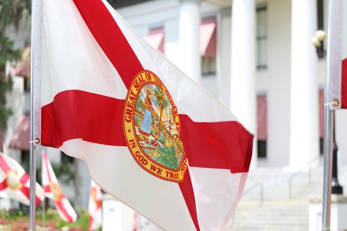 State of Florida flag that has the official seal of the state is planted at the East entrance of Old State Capitol in Tallahassee, Florida.