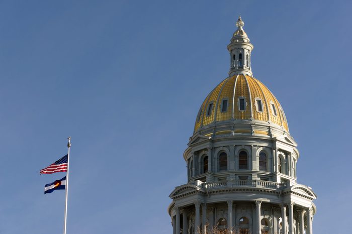 The US and State flags fly at Denver's Capital