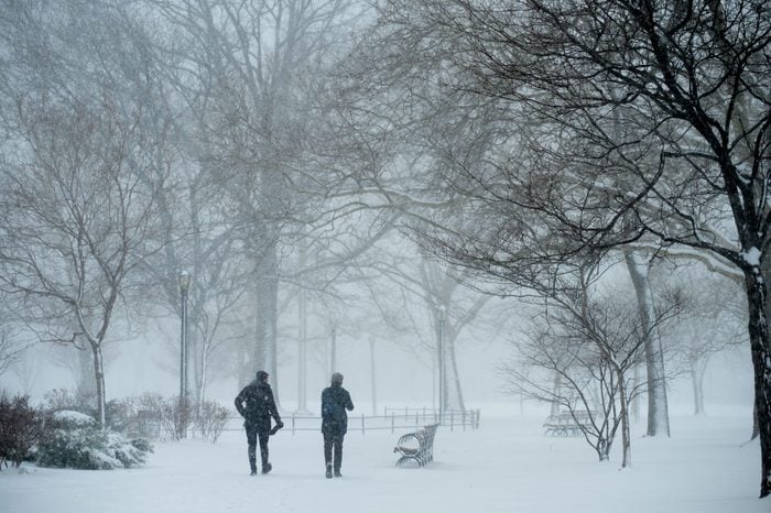 People walk through the streets of Brooklyn as a spring nor'easter