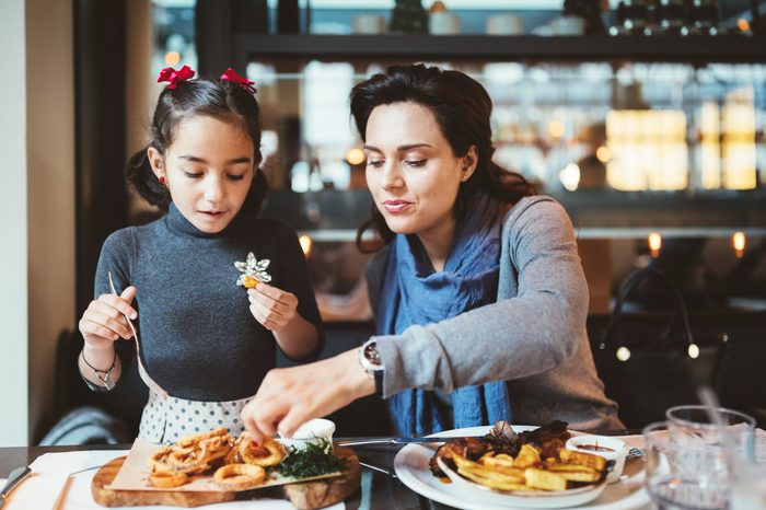 mother and daughter enjoying a meal in a restaurant