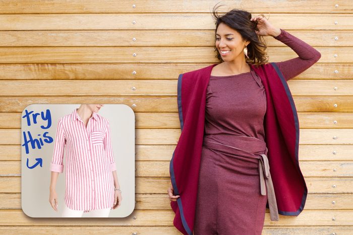 happy woman standing against wall with inset of shirt to buy