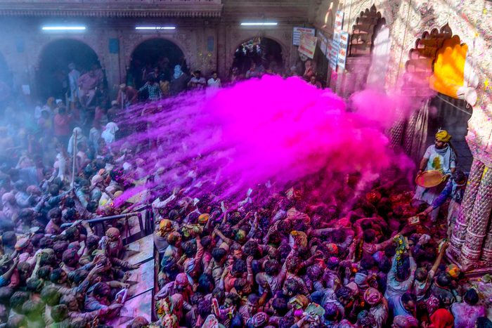 India Holi Festival spring , People celebrate the Holi festival and receive rose color powder at the Banke Bihari Temple