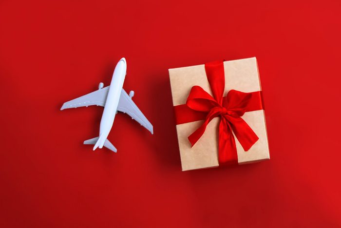 toy plane and gift on red background