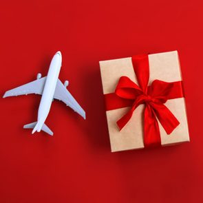 toy plane and gift on red background
