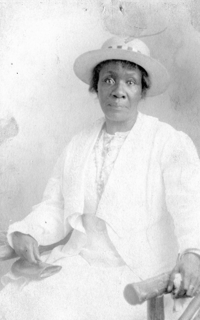 African-American mature woman wearing hat and formal dress fashion vintage 1920s