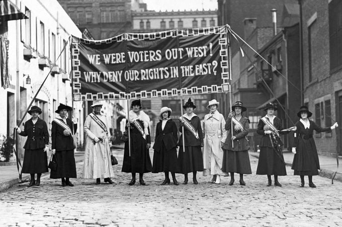 Suffragettes displaying banners at Washington Mews in Greenwich Village, New York City, ca. 1912.