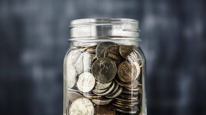 Savings jar filled with coins
