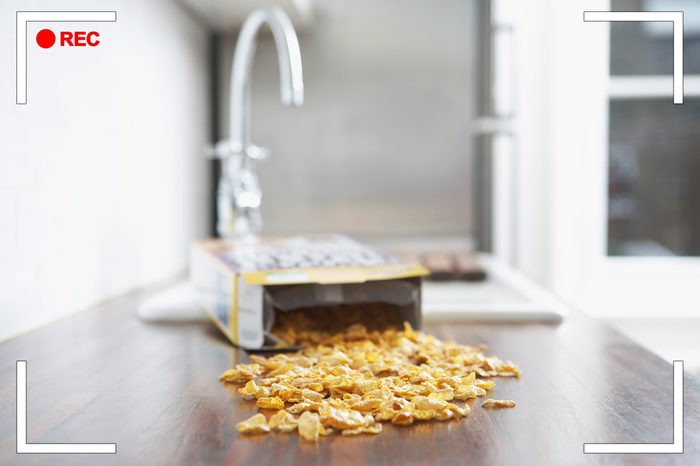 spilled box of cereal on a kitchen counter. shallow depth of field.