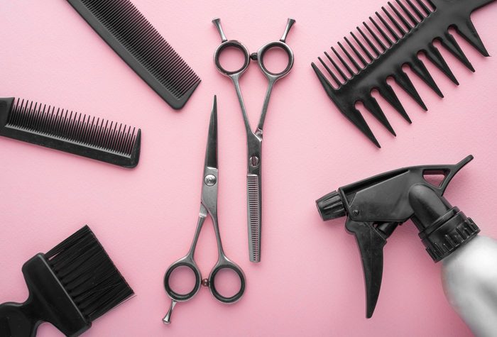 Professional hairdresser tools top view. on pink background.