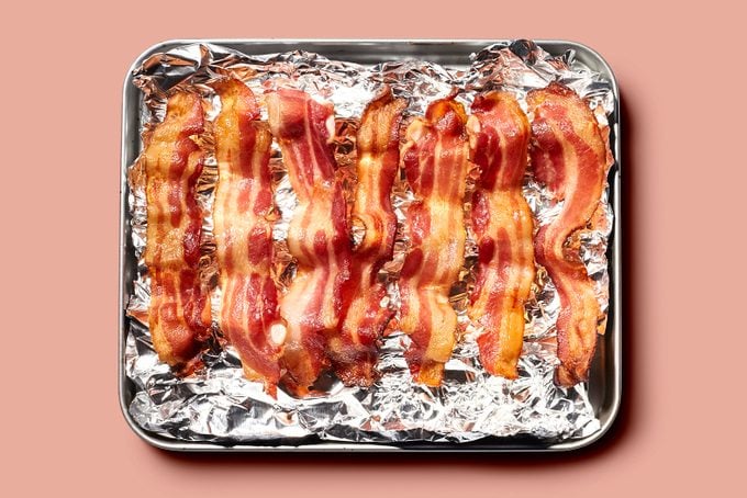 strips of bacon on tinfoil on oven tray