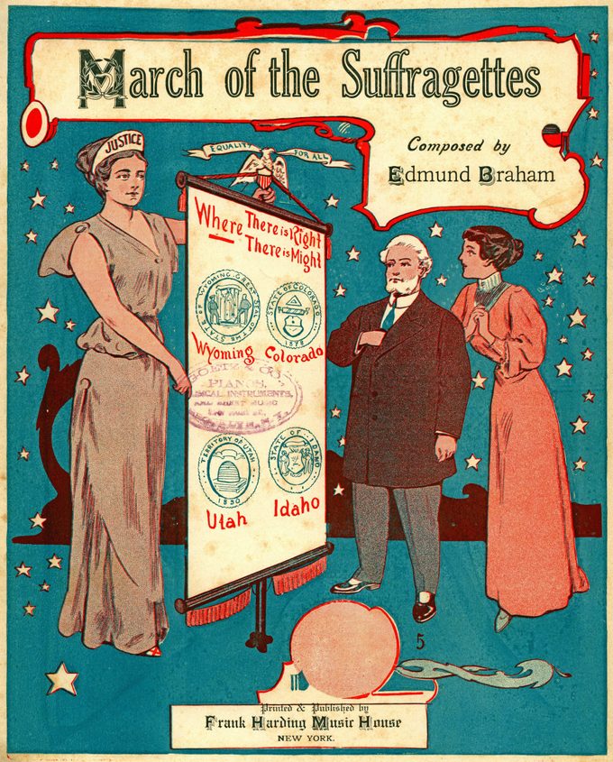 Sheet music cover for Edmund Braham's 'March of the Suffragettes,' with an illustration of a mature man and young woman, each looking at a female personification of justice who holds a scroll with seals of four states (Wyoming, Colorado, Utah, and Ohio) which had granted women the right to vote, published in New York, by Frank Harding Music House, for the American market, 1912.