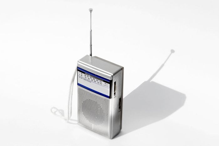 small silver portable radio on gray background